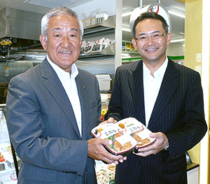 店内調理弁当を手にする中山勇ファミリーマート社長（右）と藤尾政弘フジオフードシステム社長