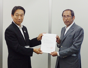 北岡寛之部長（左）から認定書を受ける岩田孝逸社長