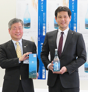 新商品を手にする林芳宏広報戦略部長兼広報官（左）と宮崎紘二マーケティング室次長