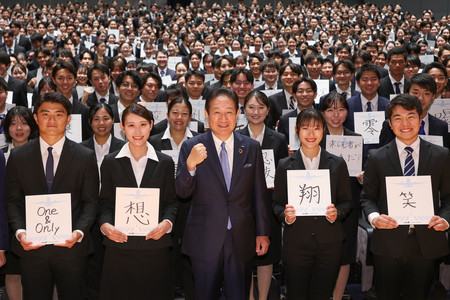 色紙を手にした内定者と全日本空輸の井上慎一社長（前列中央）＝１日午後、東京都江東区